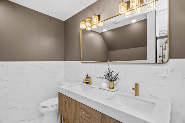 full bathroom featuring lofted ceiling, double vanity, a sink, and toilet