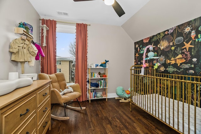 bedroom with lofted ceiling, ceiling fan, dark wood-style flooring, visible vents, and baseboards