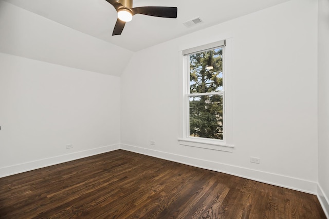 unfurnished room featuring baseboards, visible vents, and dark wood finished floors