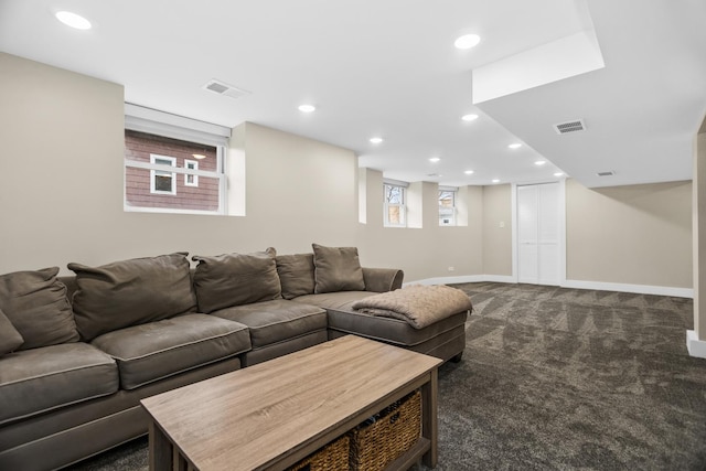 living area featuring dark colored carpet, visible vents, baseboards, and recessed lighting