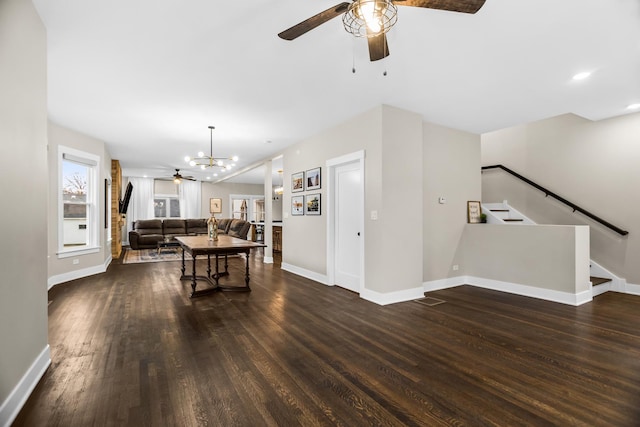 dining room with baseboards, plenty of natural light, stairway, and dark wood-type flooring