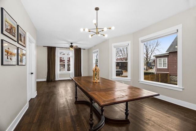 dining area with baseboards, a chandelier, and wood finished floors