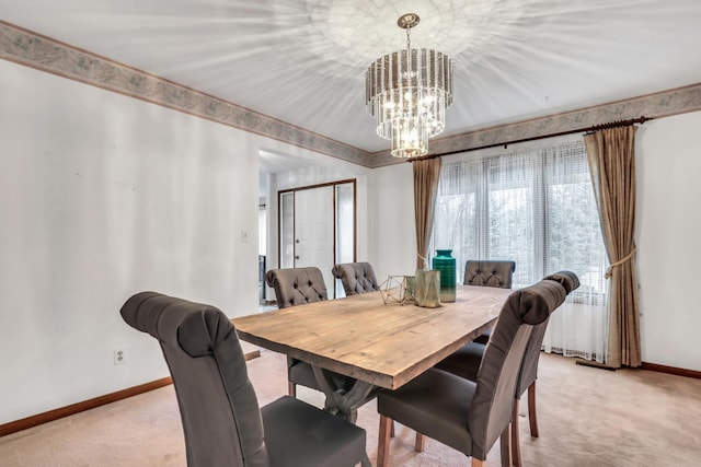 dining room featuring an inviting chandelier, baseboards, and light colored carpet