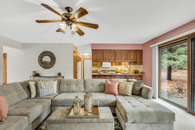 living room with wallpapered walls and ceiling fan