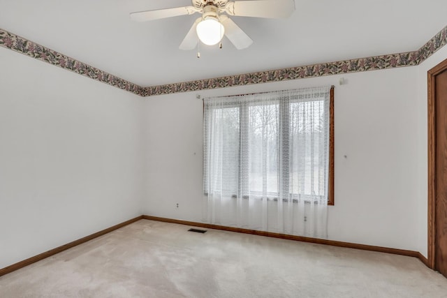 empty room with light carpet, plenty of natural light, visible vents, and baseboards