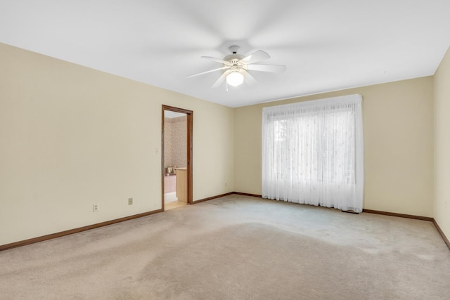 spare room featuring carpet flooring, a ceiling fan, and baseboards