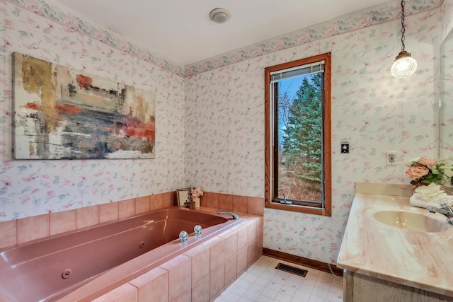 full bath with vanity, baseboards, visible vents, a whirlpool tub, and wallpapered walls