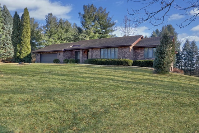 single story home with a garage, brick siding, and a front yard