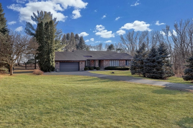 ranch-style house featuring aphalt driveway, a front yard, brick siding, and an attached garage