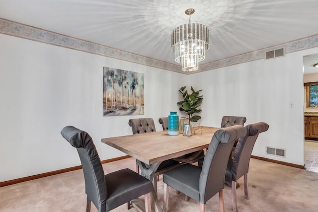 dining space with baseboards, visible vents, a chandelier, and light colored carpet