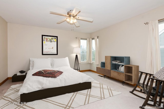 carpeted bedroom with baseboards and a ceiling fan