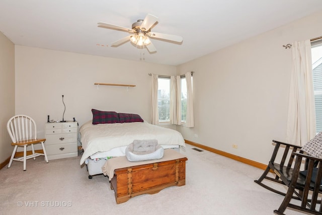 bedroom featuring ceiling fan, carpet floors, visible vents, and baseboards