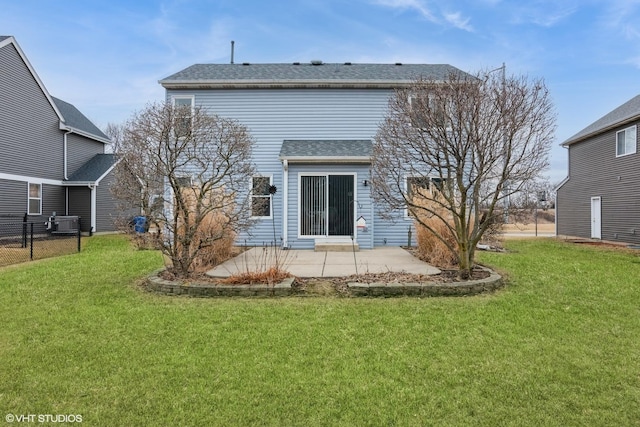 rear view of house featuring a patio, a lawn, fence, and roof with shingles