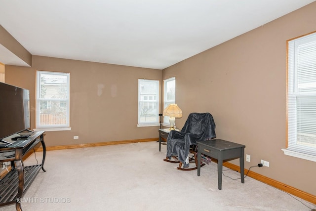 sitting room featuring a wealth of natural light, baseboards, and carpet flooring