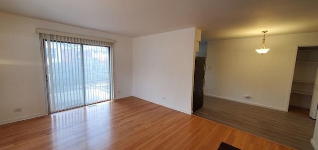 empty room featuring baseboards and wood finished floors