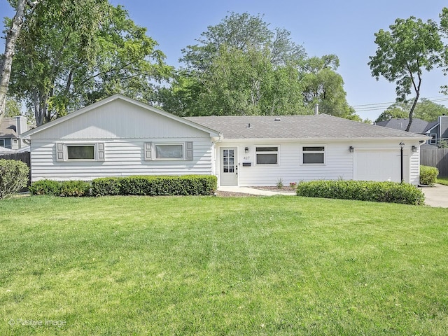 ranch-style home featuring a garage, driveway, and a front lawn