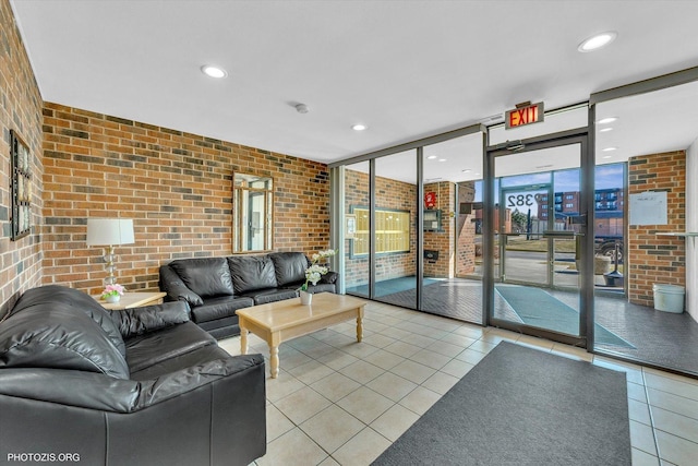 tiled living area featuring recessed lighting, expansive windows, and brick wall