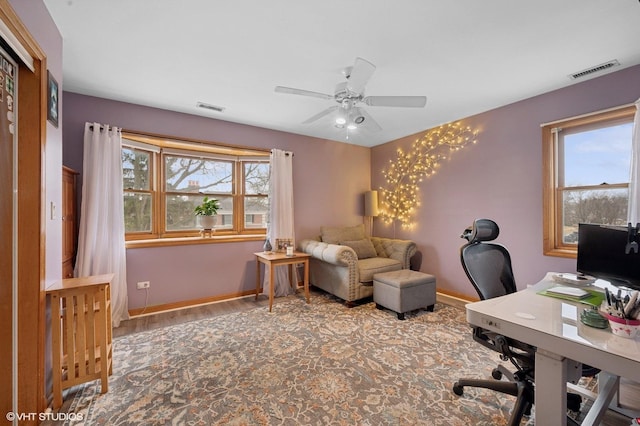 office space with plenty of natural light, visible vents, and baseboards