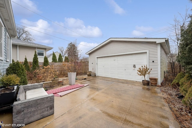 detached garage featuring fence