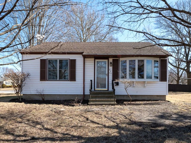 view of front of property featuring entry steps and roof with shingles