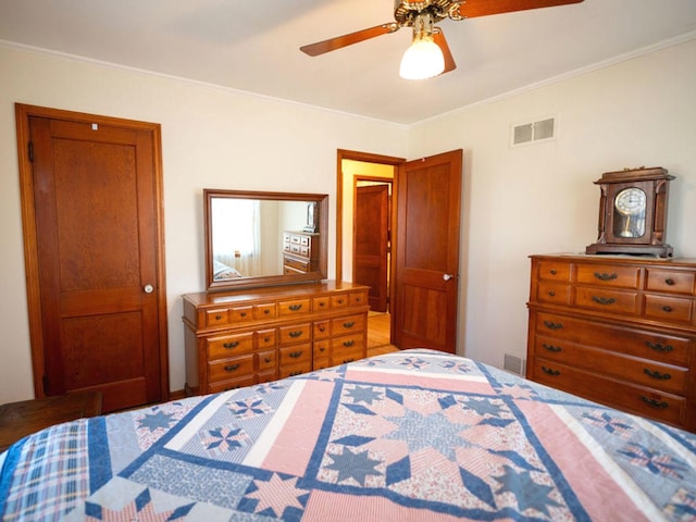 bedroom with visible vents, ceiling fan, and crown molding