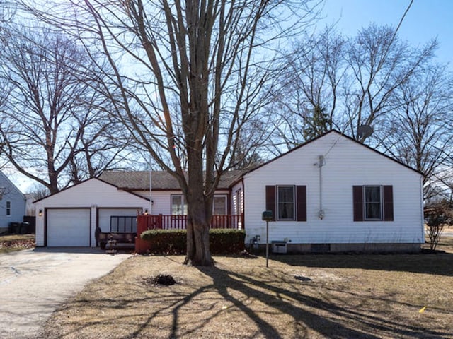 single story home featuring a garage and an outbuilding