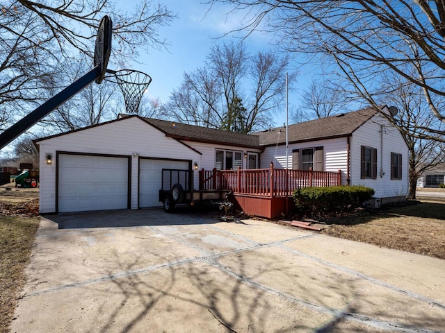 ranch-style house with a deck, driveway, and a garage