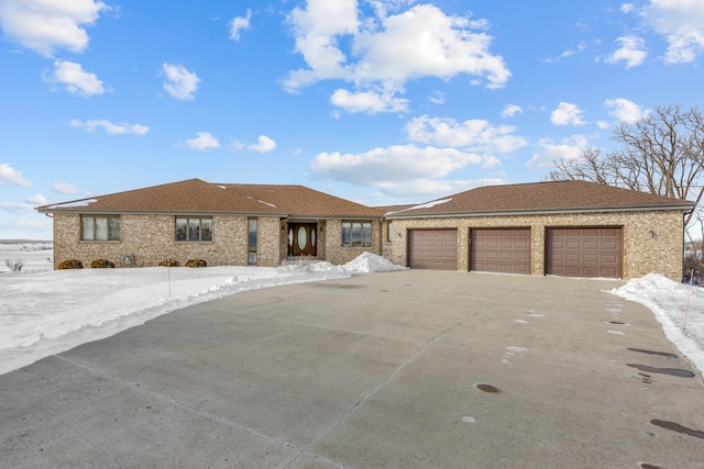 view of front of home with concrete driveway, brick siding, an attached garage, and a shingled roof