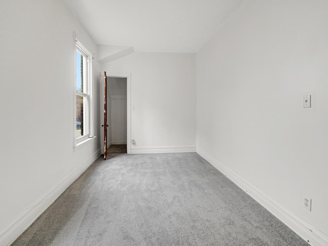 spare room with carpet flooring and baseboards