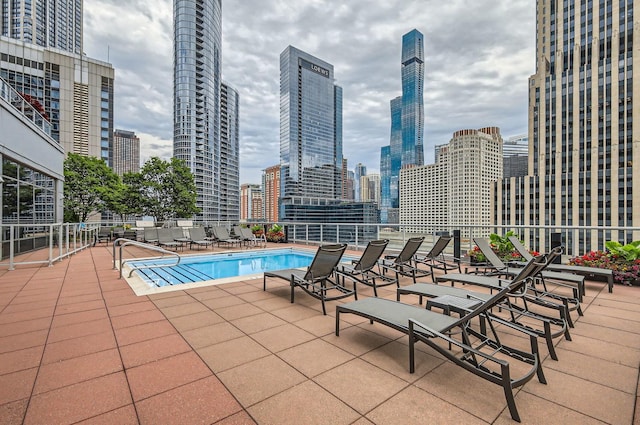 pool featuring a view of city and a patio