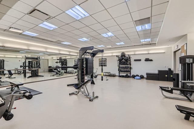 gym with a paneled ceiling