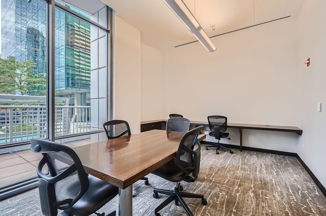 office space with baseboards and floor to ceiling windows