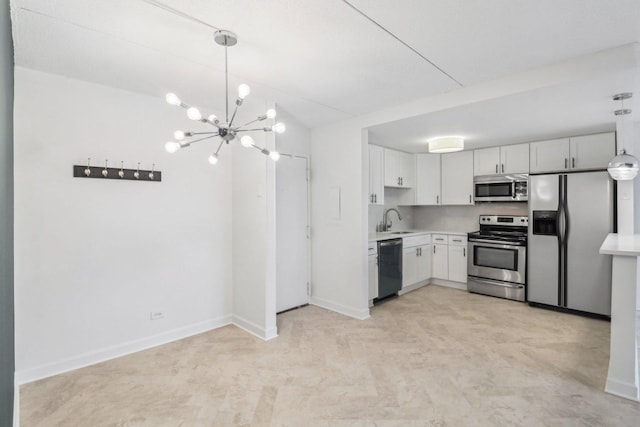 kitchen featuring light countertops, baseboards, appliances with stainless steel finishes, and a sink