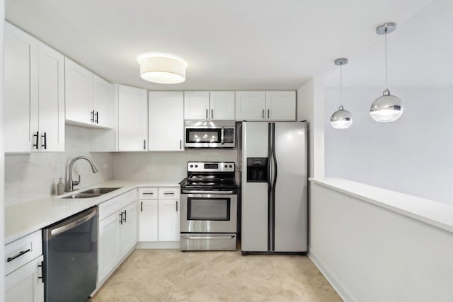 kitchen featuring a sink, stainless steel appliances, white cabinetry, and light countertops