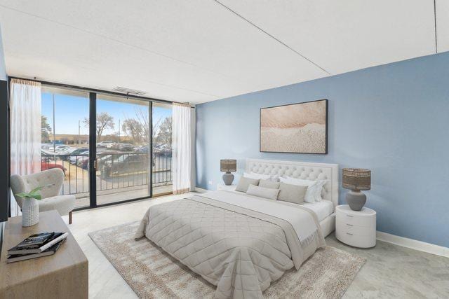 bedroom featuring access to outside, baseboards, and expansive windows