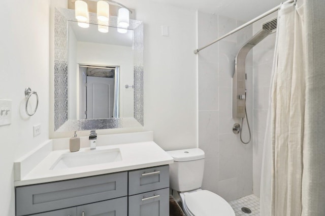 bathroom featuring a shower stall, vanity, and toilet