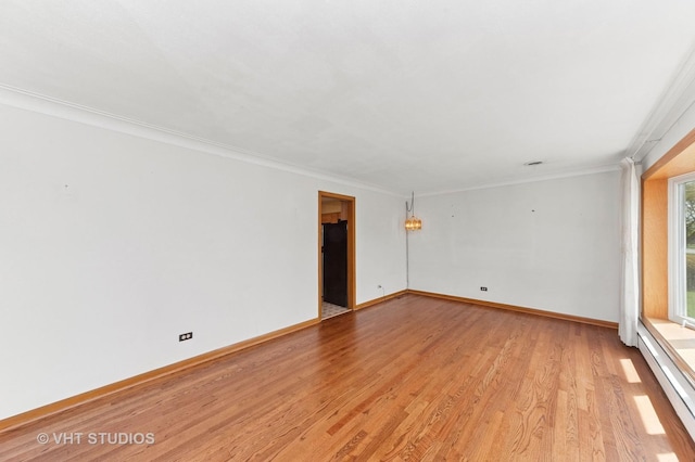 6938 W Jonquil Ter, Niles, IL 60714 - unfurnished room featuring light wood-type flooring, baseboard heating, crown molding, and baseboards