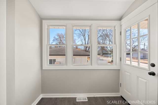 unfurnished sunroom featuring vaulted ceiling and visible vents