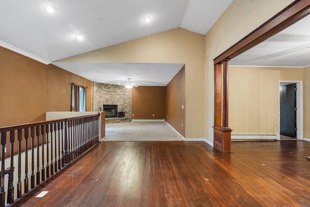 unfurnished living room with ceiling fan, lofted ceiling, baseboard heating, a fireplace, and wood-type flooring