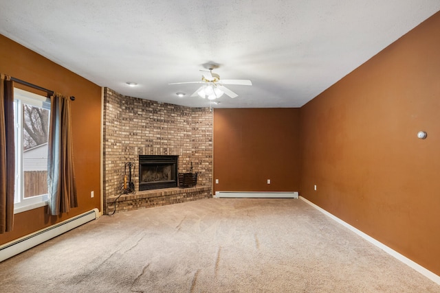 unfurnished living room with a baseboard heating unit, carpet floors, a textured ceiling, and a brick fireplace