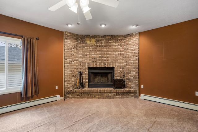 unfurnished living room with carpet floors, a brick fireplace, a ceiling fan, and a baseboard radiator