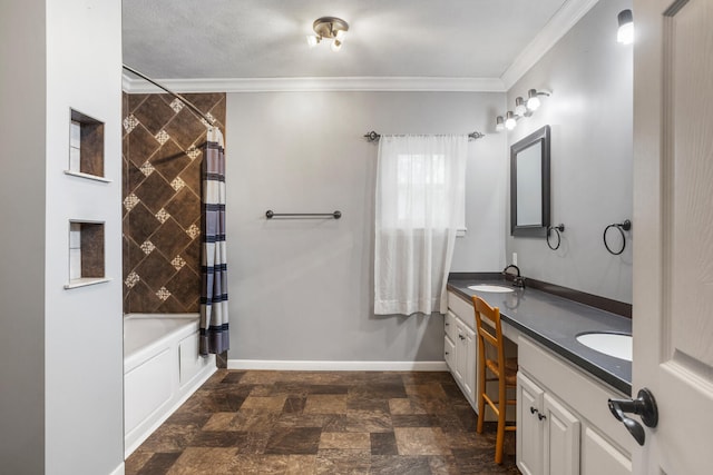 full bath featuring baseboards, double vanity, a sink, stone finish flooring, and crown molding