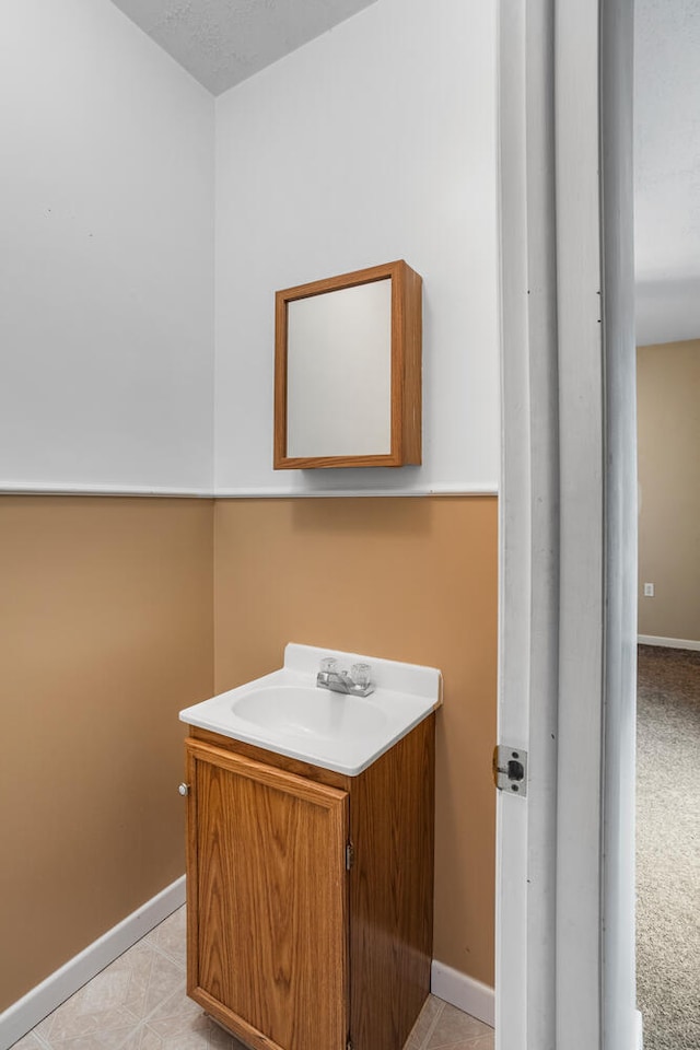 bathroom with vanity and baseboards