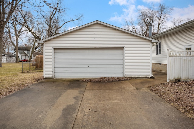 detached garage featuring fence