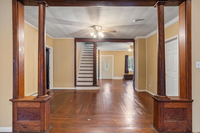 interior space featuring hardwood / wood-style floors, radiator, a ceiling fan, stairs, and crown molding