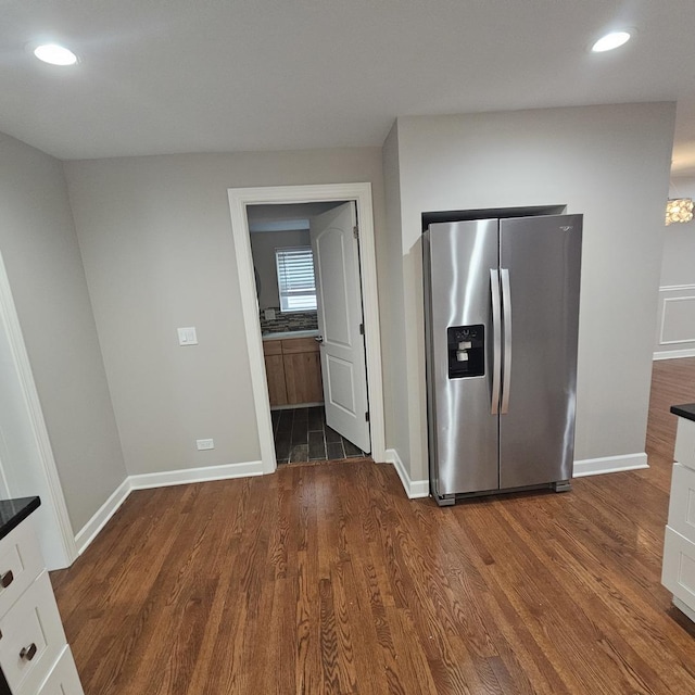 kitchen featuring recessed lighting, white cabinetry, baseboards, stainless steel fridge with ice dispenser, and dark wood-style floors