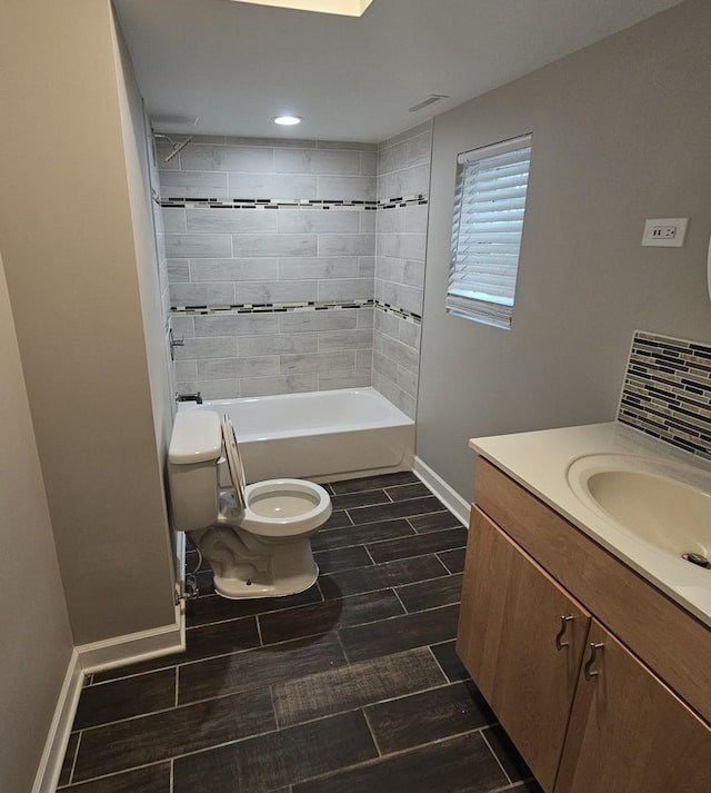 full bathroom with wood finish floors, tasteful backsplash, toilet, vanity, and baseboards