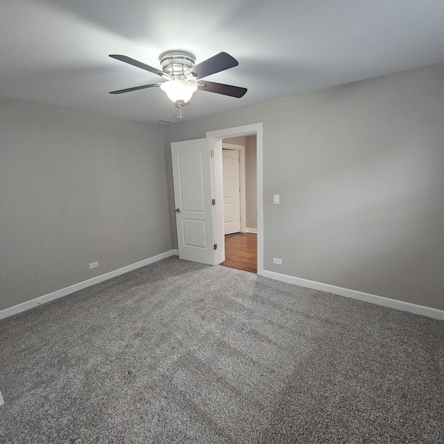 empty room featuring carpet floors, ceiling fan, and baseboards