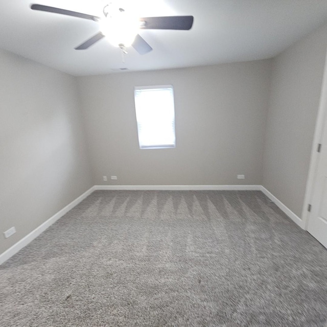 empty room featuring carpet, ceiling fan, and baseboards