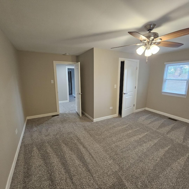 unfurnished bedroom with a ceiling fan, carpet flooring, visible vents, and baseboards